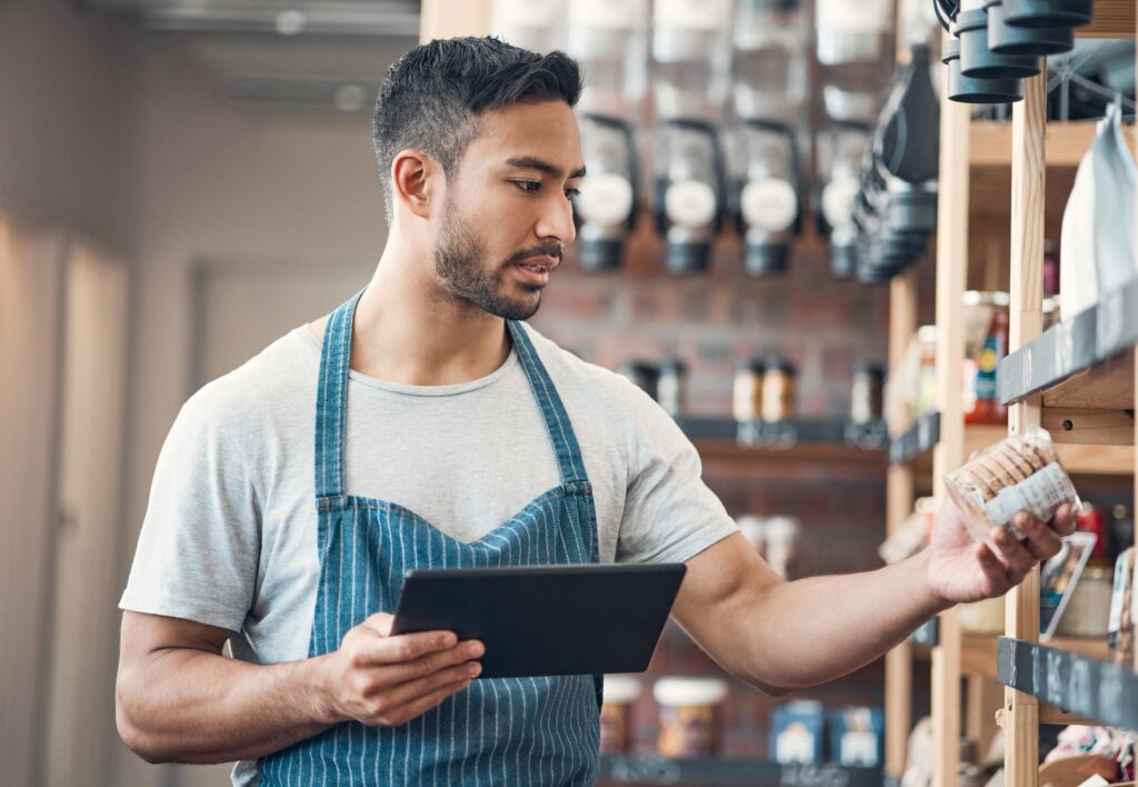 An employee inspecting coffee placement and facing
