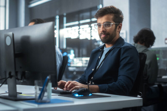 Mid,Adult,Man,Using,A,Computer,While,Working